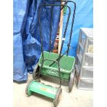 A Challenge lawn mower and seed box spreader.