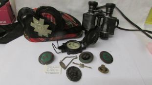 A Scottish military cap, field glasses, compass, German and other badges.