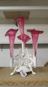 A white painted metal and cranberry glass epergne, centre trumpet has chips to base,