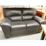 A black 2 seater leather sofa in good condition.