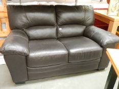 A black 2 seater leather sofa in good condition.