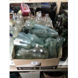 A large box of 'local' clear bottles 7 a tub of 'chemists' type bottles