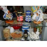 Two shelves of assorted ceramics including novelty jam pots etc.