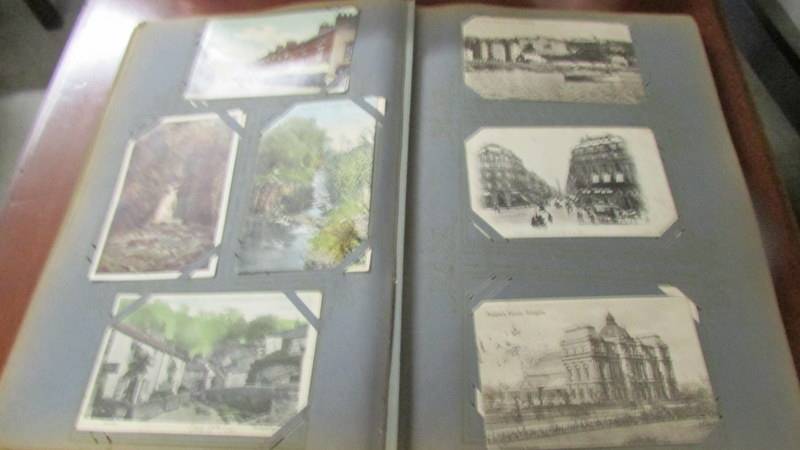 An album of approximately 180 vintage postcards. - Image 5 of 12