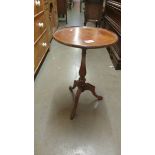 A mahogany inlaid tripod wine table (a/f on top).