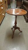 A mahogany inlaid tripod wine table (a/f on top).