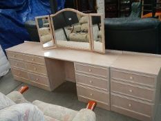 A white dressing table with triple mirror and pair of matching bedsides.