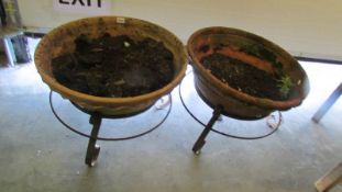 A pair of early wrought iron and terracotta planters