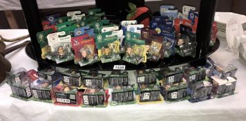 Approximately 50 carded football figures including soccer starz,