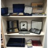 3 shelves of boxed/cased cutlery sets