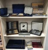 3 shelves of boxed/cased cutlery sets