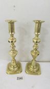 A good pair of Victorian brass diamond candlesticks, 28 cm tall.