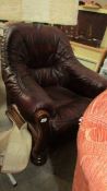 A tan wood framed arm chair. in good condition.