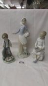 Three NAO figurines - Girl with dog, boy with dog and girl writing on a slate.