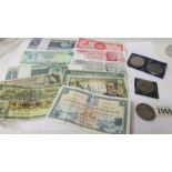 A quantity of old coins and banknotes.