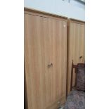 A pair of light oak effect melamine double door wardrobes with drawer, 81 x 53 x 182 cm high.