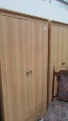 A pair of light oak effect melamine double door wardrobes with drawer, 81 x 53 x 182 cm high.