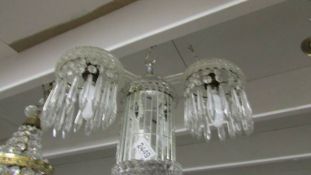 An unusual contemporary three lamp glass chandelier.