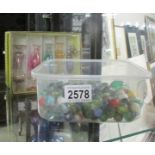 A quantity of glass marbles and five glass scent bottles.
