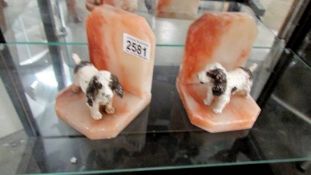 A pair of 1930's spelter spaniels on pink marble book ends.