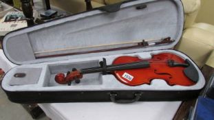 A modern cased violin with bow. (size 13.75").