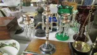 A silver plate candelabra's with glass droppers.