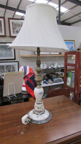 A vintage onyx and gilded white metal table lamp with shade, overall height 67 cm, lamp 51 cm.