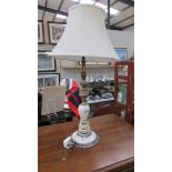 A vintage onyx and gilded white metal table lamp with shade, overall height 67 cm, lamp 51 cm.