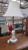 A vintage onyx and gilded white metal table lamp with shade, overall height 67 cm, lamp 51 cm.