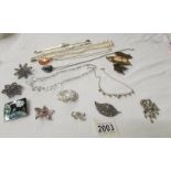 A mixed lot of costume jewellery including pendants, necklaces and brooches.
