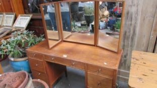 A mahogany triple mirror dressing table.