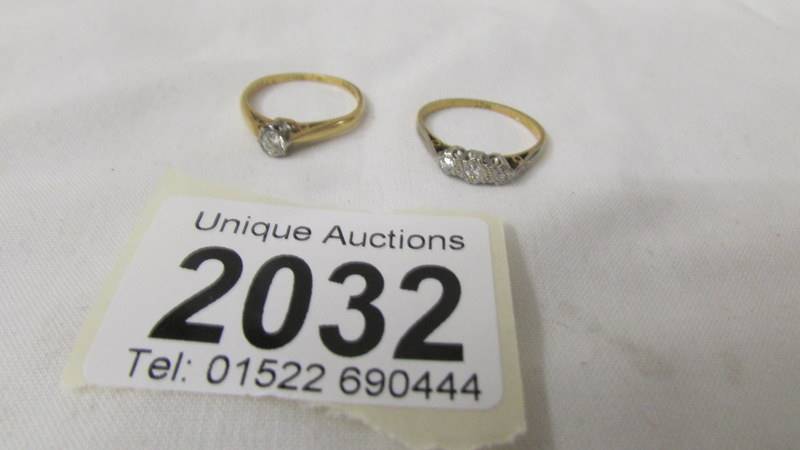 An 18ct gold ring set (2.3 grams) and an 18ct gold diamond solitaire ring (2.5 grams).