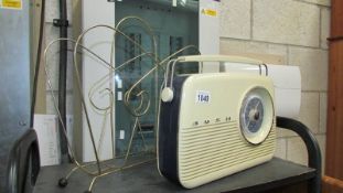 A retro Bush TR82 radio and a retro wire magazine rack.