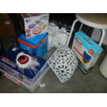 A large box with hand held vacuum cleaner, assorted cleaning items, space saving vacuum bags,