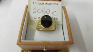 An 18ct (750) gold and onyx ring, size S, total weight 8 grams.