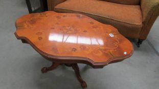 An ornate Italian inlaid coffee table on centre column with four legs (need one fitting bolt for