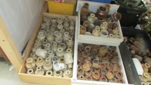 Three boxes of stoneware bottles and jars.