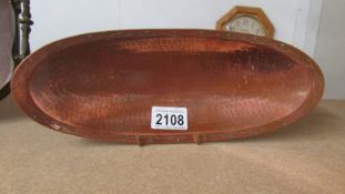 An Arts & Crafts copper dish, stamped L.R.I. Borrowdale, hand beaton, 29.5 x 11.5 cm.