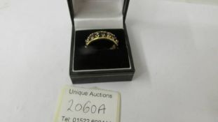 An 18ct gold band ring set sapphires and small diamonds, size R. 6.9 grams.