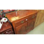 A dark wood stained 2 drawer cupboard with folding top, 96 x 48 x 87 cm high.