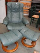 A green leather revolving chair and 2 stools.