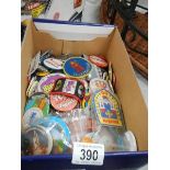 A box of assorted badges.