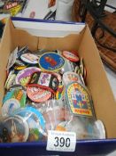 A box of assorted badges.