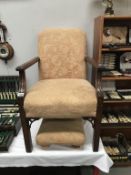A vintage armchair with matching foot stool