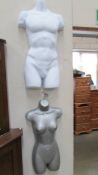 Two shop display male and female wall hanging mannekins.
