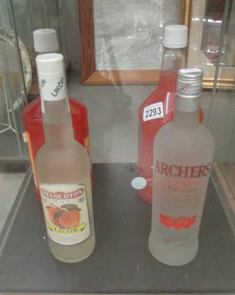 A bottle of Archers Cranbetty Schnapps, a bottle of peach liquor and 2 large bottles of rum punch.