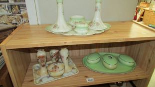 A 1930's Limoges floral porcelain trinket set and other porcelain dressing table items.