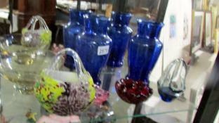 A mixed lot of coloured glass including two blue glass vases.