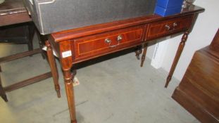 A two drawer mahogany side table.
