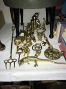 A quantity of brassware ornaments including corkscrew etc.